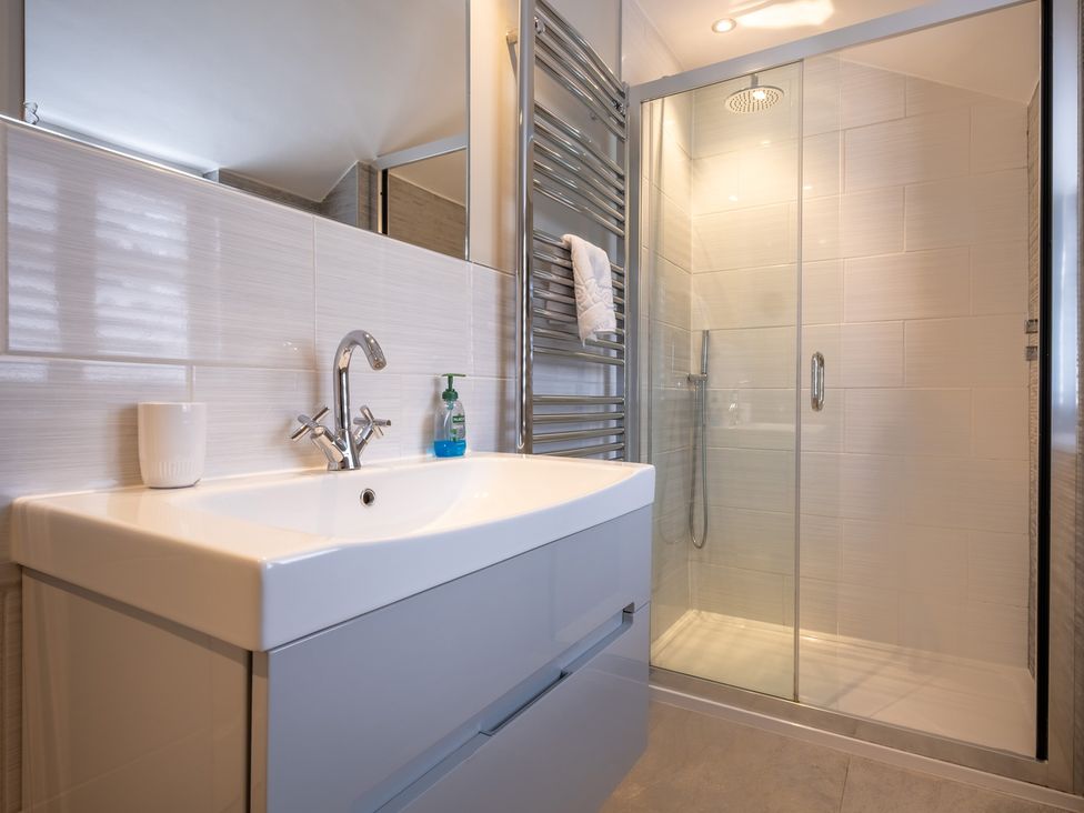 A bathroom with a sink and shower enclosure at Goody Raise in Grasmere