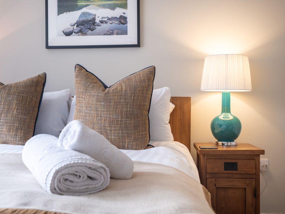 A bedroom with a bed and nightstand at Goody Raise in Grasmere