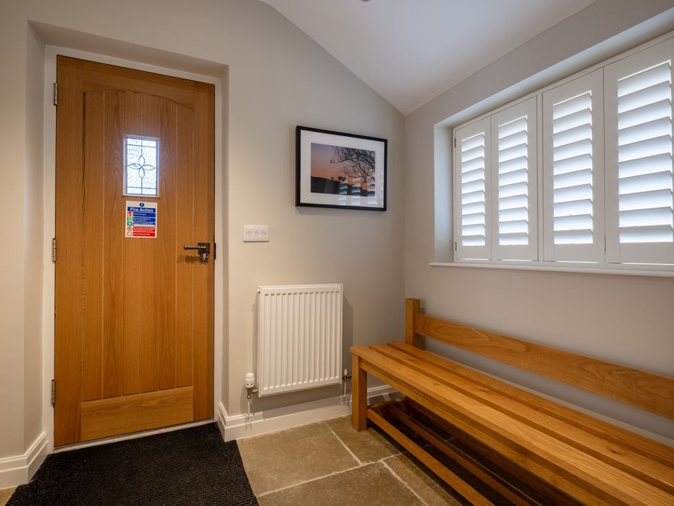 A hallway with a door and a bench at Goody Raise in Grasmere