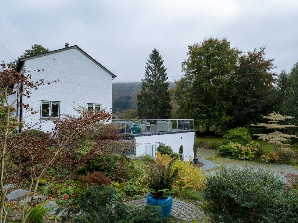 A house with a garden and decking area at Goody Raise in Grasmere
