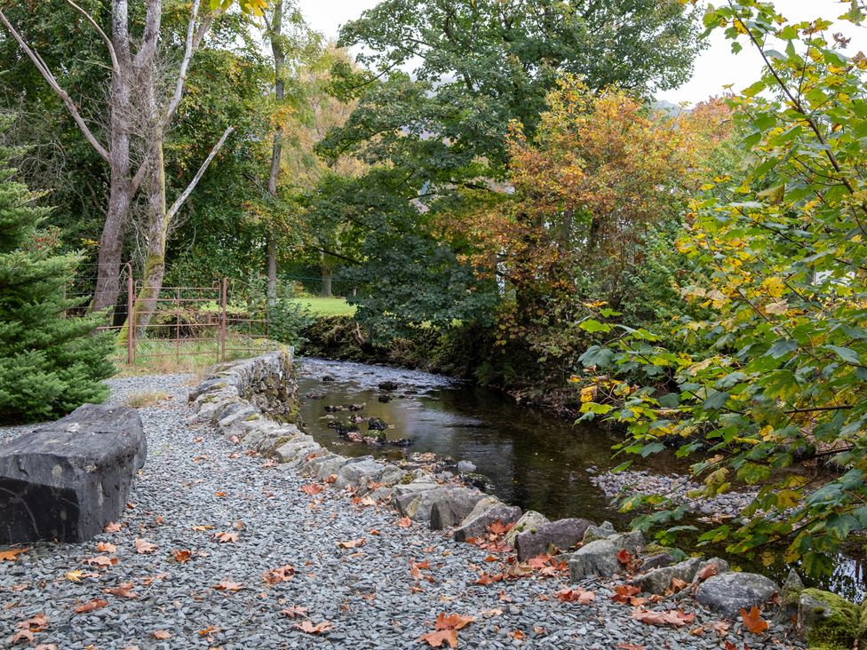 A stream with rocks and trees at Goody Raise in Grasmere