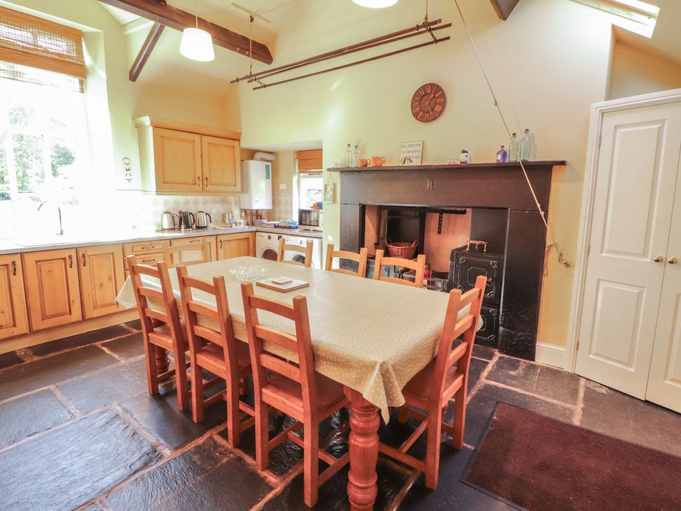 A kitchen with a dining table and chairs at Hawkshead Hall in Hawkshead