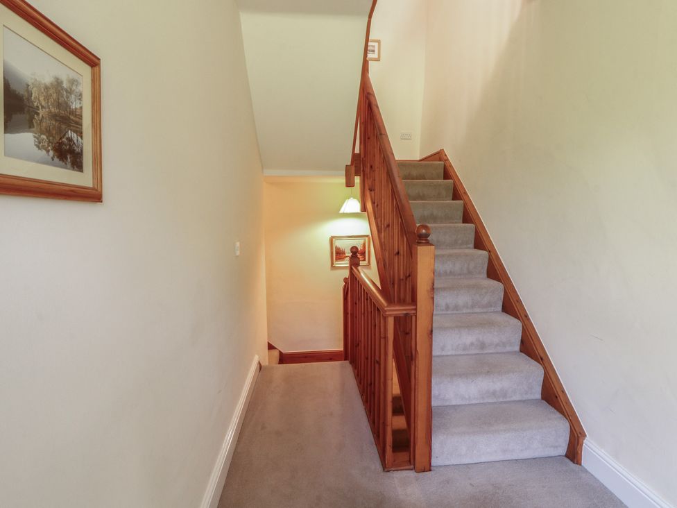 A staircase with a handrail in a hallway at Hawkshead Hall in Hawkshead