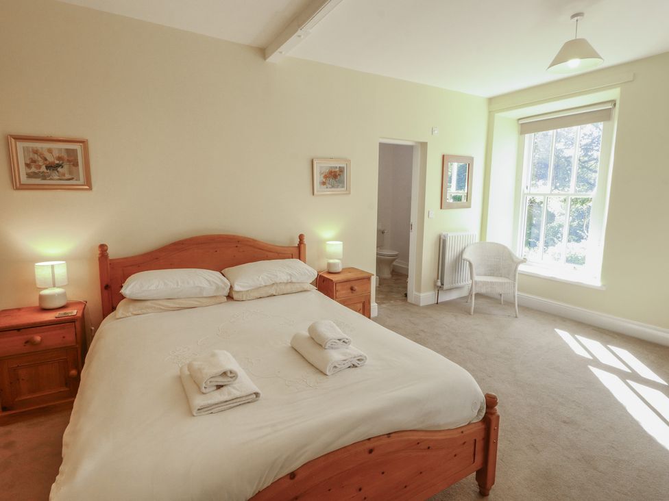 A bedroom with a bed and bedside tables at Hawkshead Hall in Hawkshead