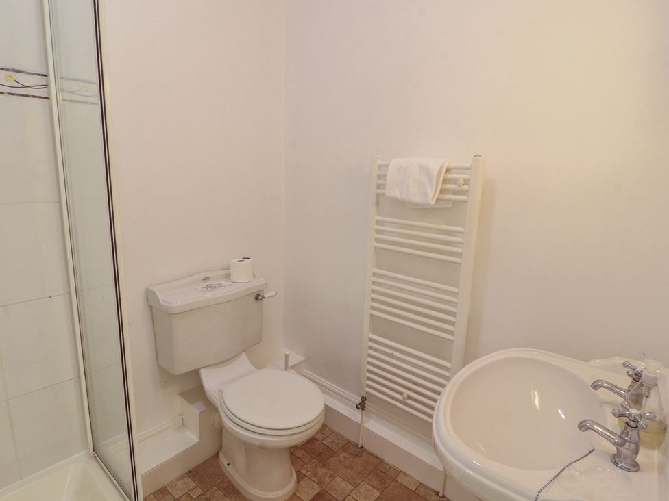 A bathroom with a toilet and sink at Hawkshead Hall in Hawkshead