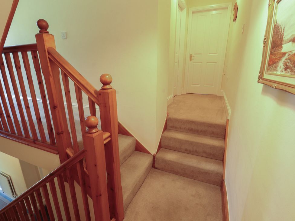 A hallway with stairs and a door at Hawkshead Hall in Hawkshead