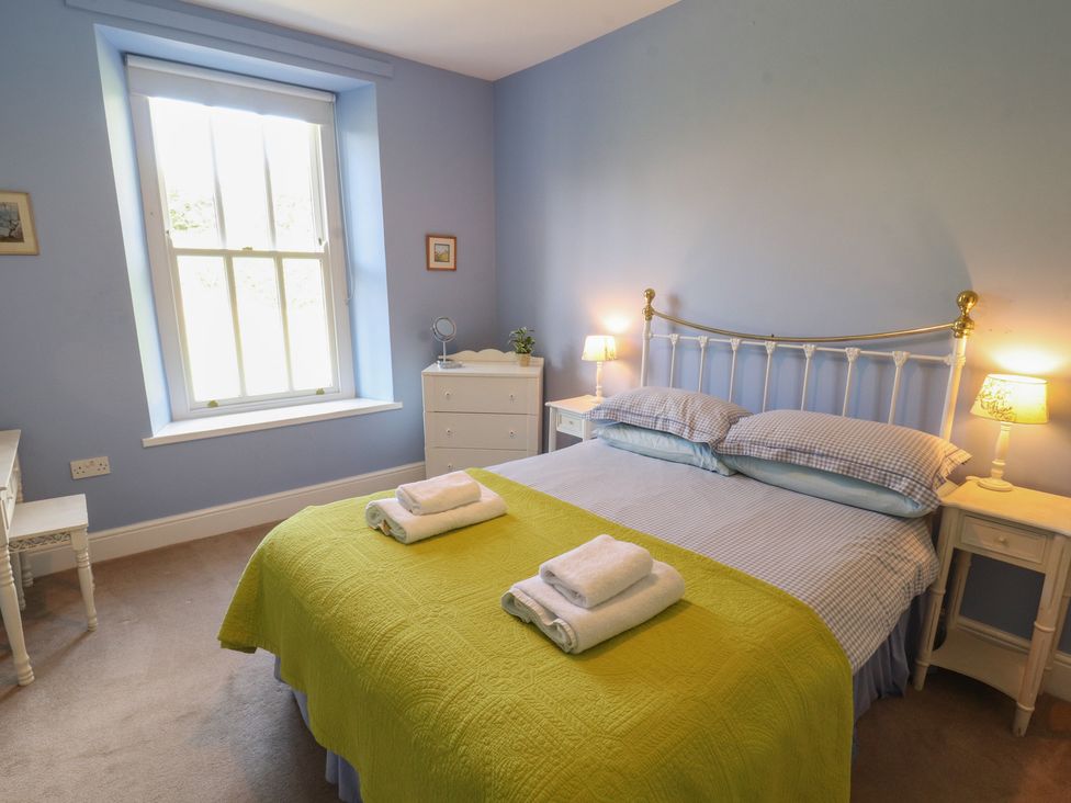 A bedroom with a bed and bedside tables at Hawkshead Hall in Hawkshead