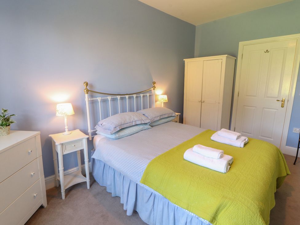 A bedroom with a bed and wardrobe at Hawkshead Hall in Hawkshead