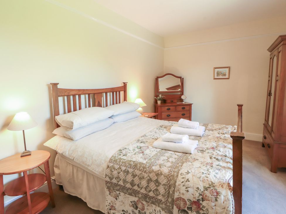 A bedroom with a bed and bedside table at Hawkshead Hall in Hawkshead