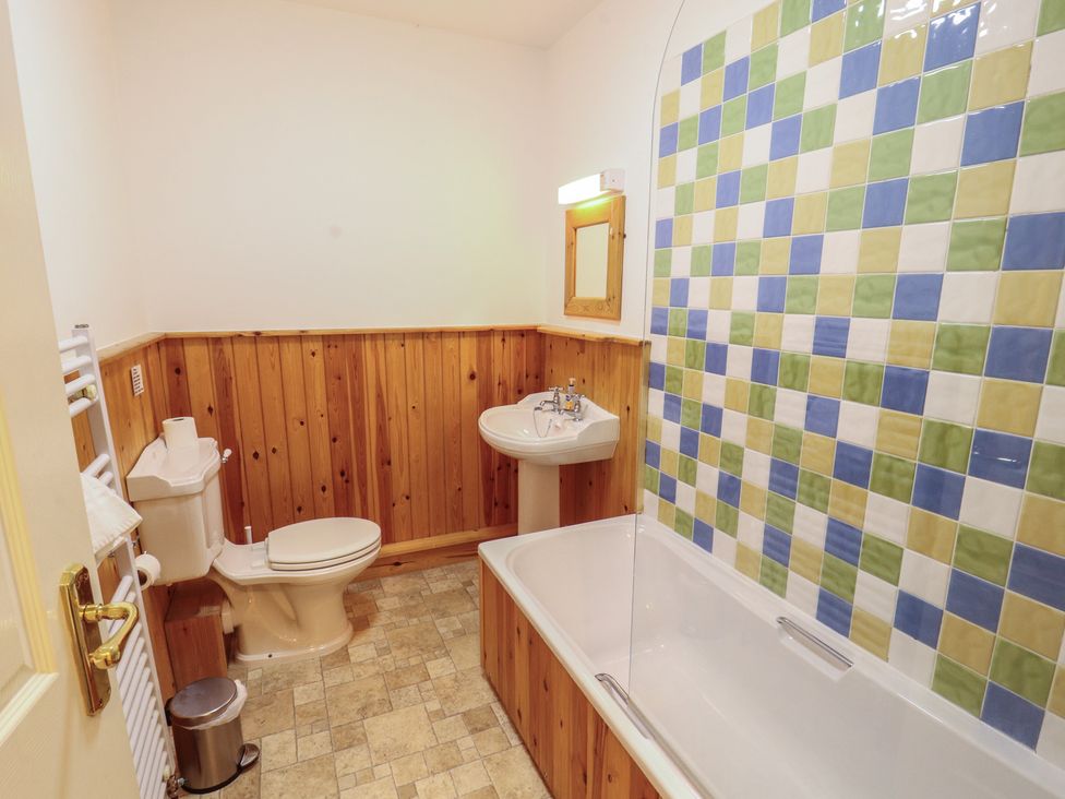 A bathroom with a sink and bathtub at Hawkshead Hall in Hawkshead