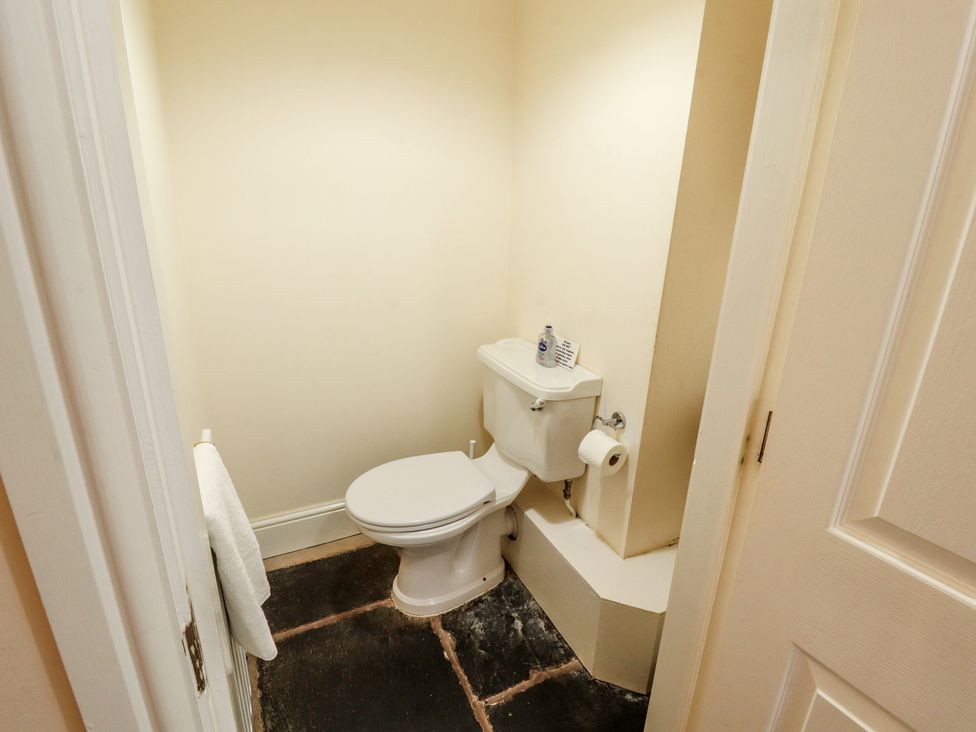 A bathroom with a toilet and hand towel at Hawkshead Hall in Hawkshead