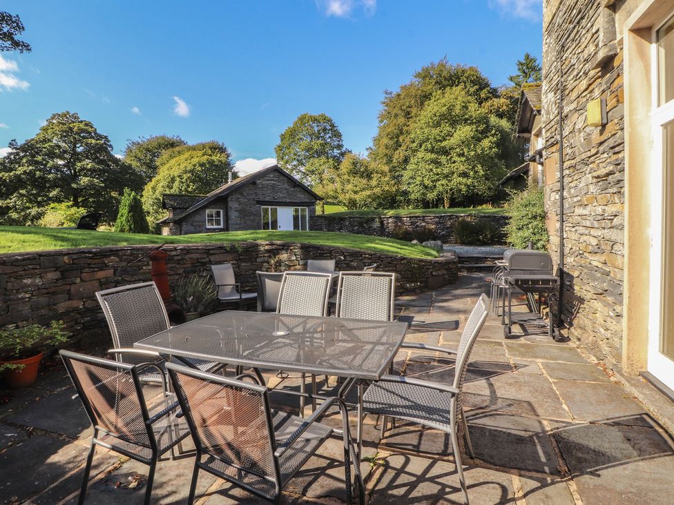 An outdoor area with a table and chairs at Hawkshead Hall in Hawkshead