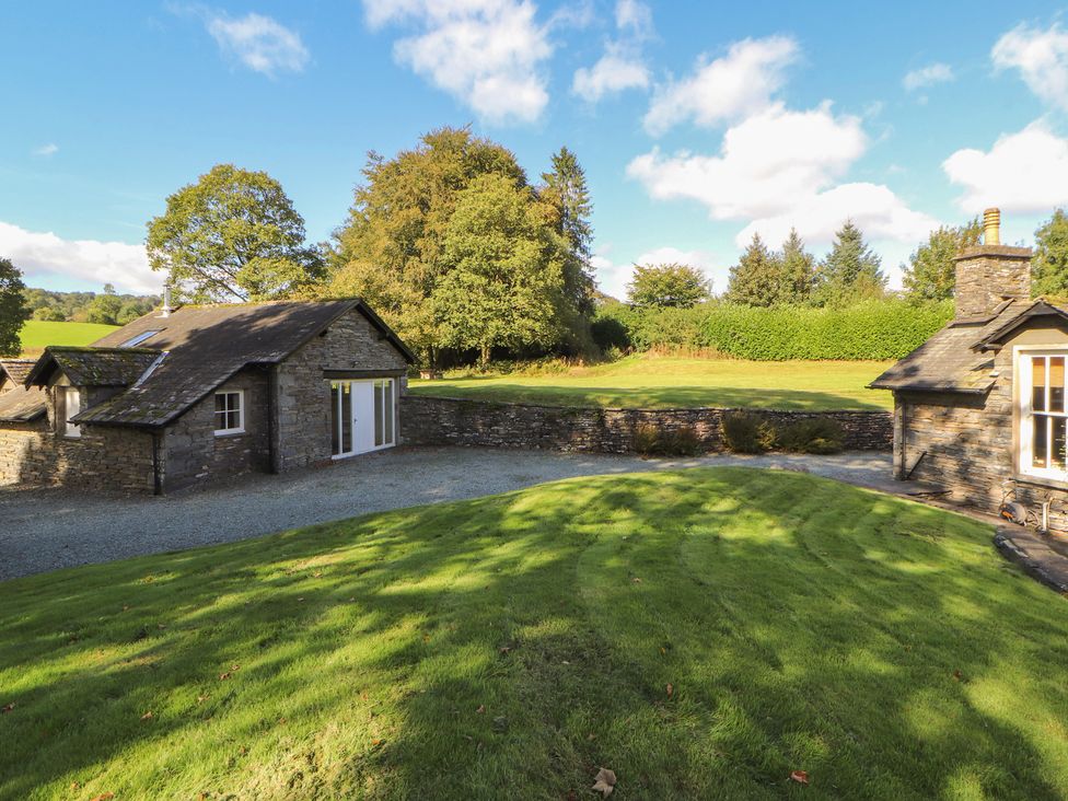 A house with a gravel pathway and lawn at Hawkshead Hall in Hawkshead