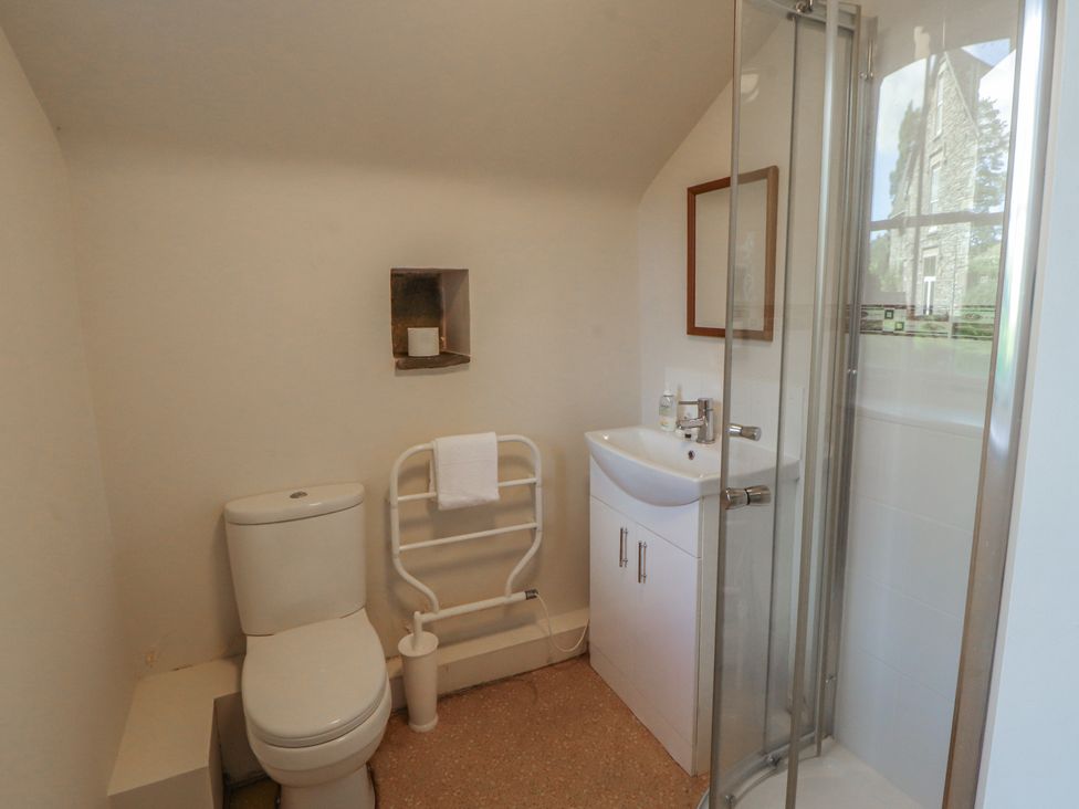A bathroom with a toilet and shower at Hawkshead Hall in Hawkshead