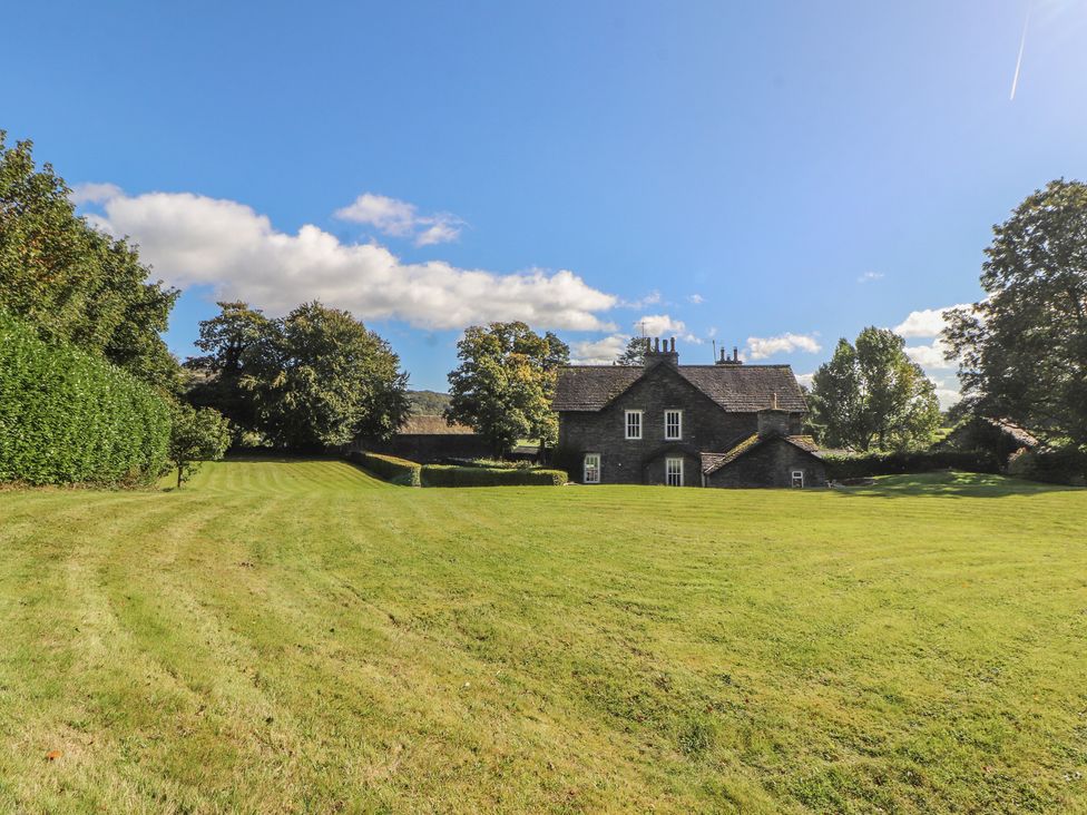 A house surrounded by grass and trees at Hawkshead Hall in Hawkshead
