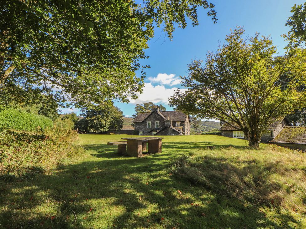An outdoor area with a table and a house at Hawkshead Hall in Hawkshead