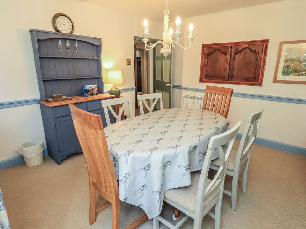 A dining room with a table and chairs at Rose Cottage Coniston