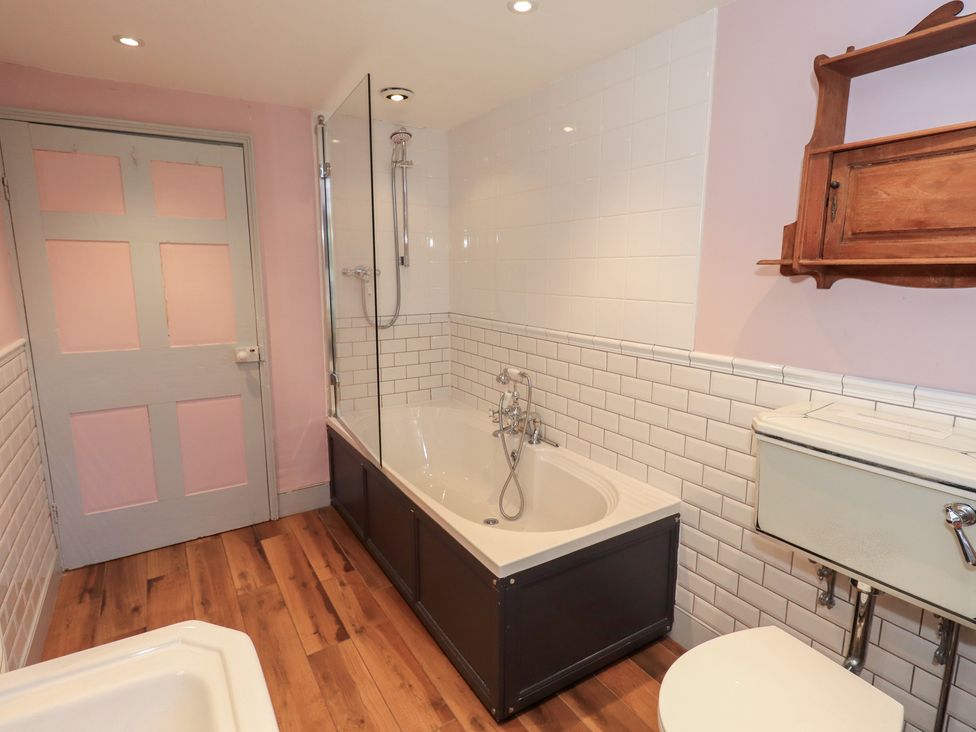 A bathroom with a bathtub, shower, and toilet at Rose Cottage Coniston
