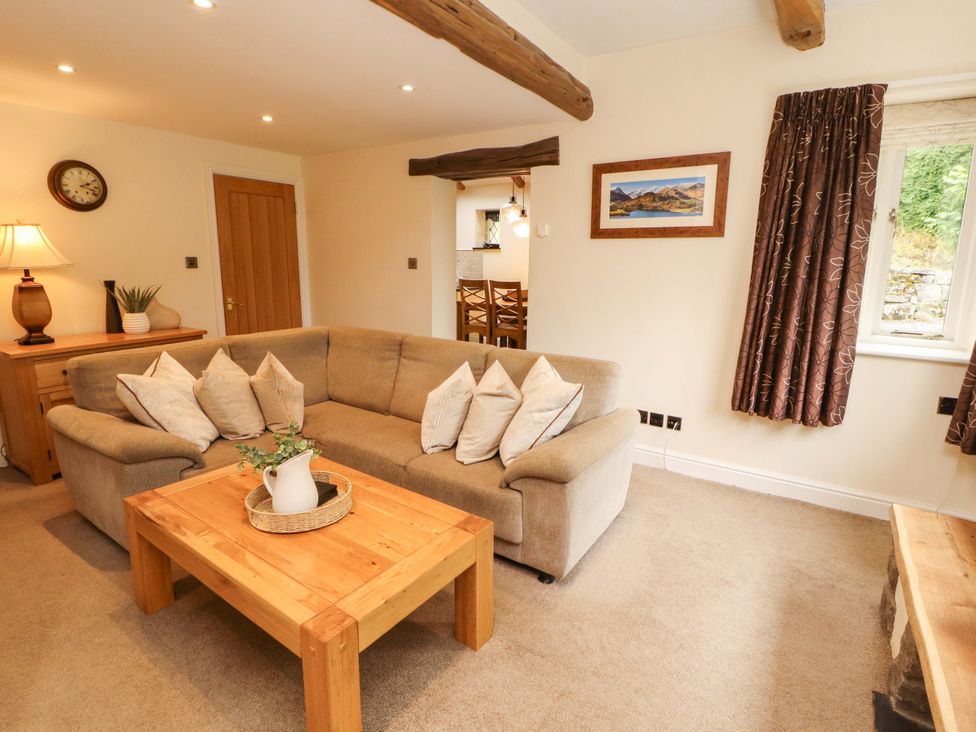 A living room with a sofa and coffee table at Durham Bridge Barn in Crosthwaite