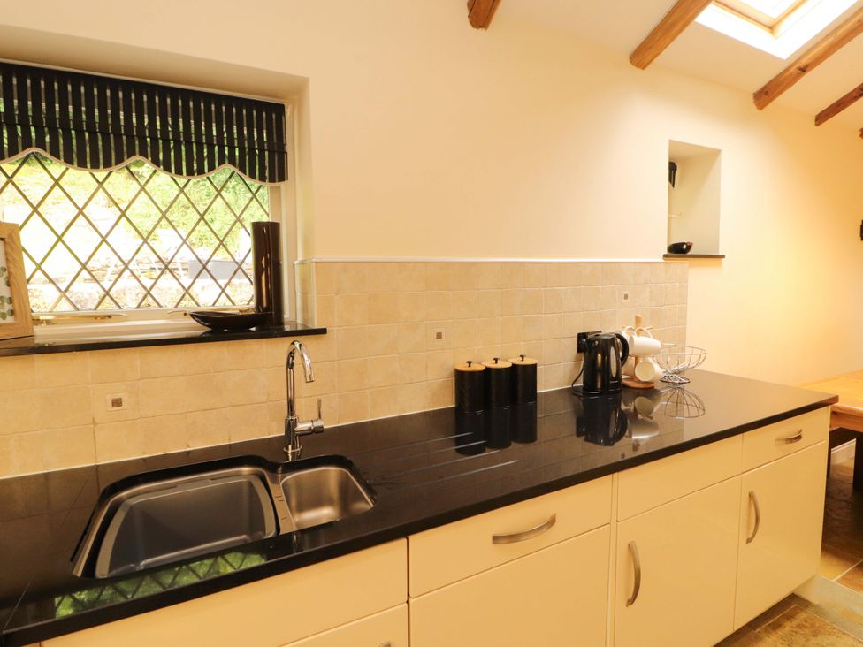A kitchen with sink and kettle at Durham Bridge Barn in Crosthwaite