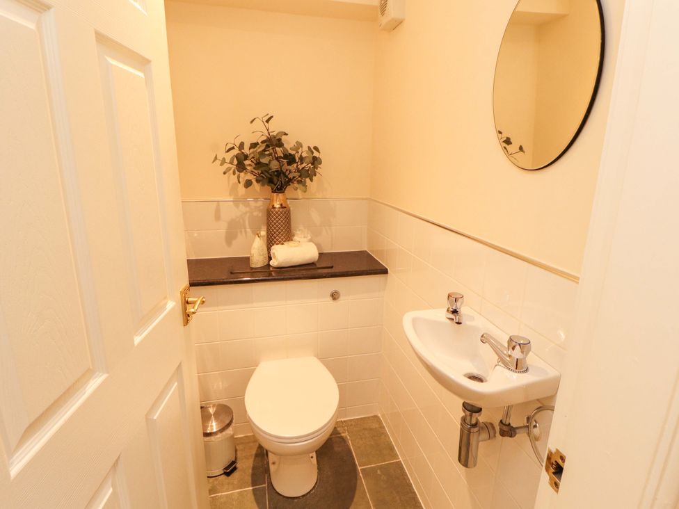 A bathroom with a toilet and sink at Durham Bridge Barn in Crosthwaite