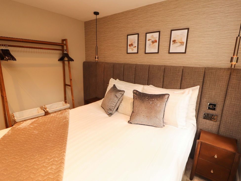 A bedroom with a bed and bedside table at Durham Bridge Barn in Crosthwaite