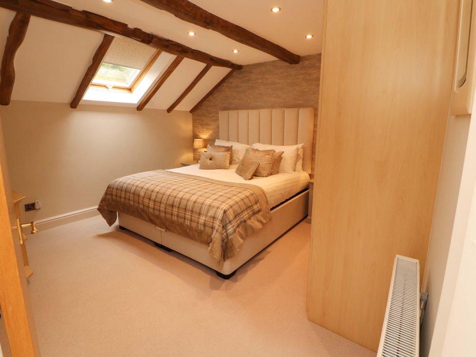 A bedroom with a bed and skylight at Durham Bridge Barn in Crosthwaite