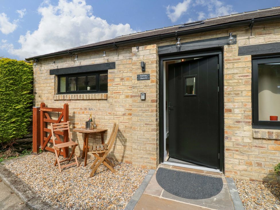 An entrance with a table and chairs at Hadrian Barn 1 in Ebchester