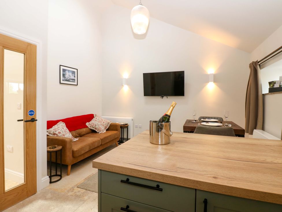 A living room with a sofa and television at Hadrian Barn 1 in Ebchester