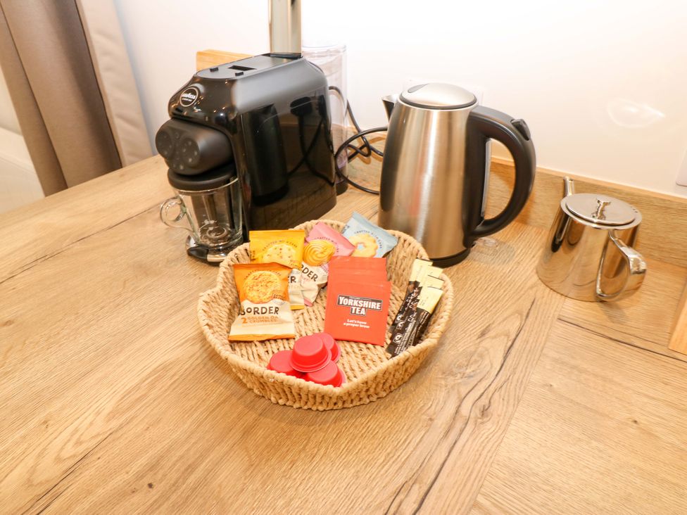A coffee machine, kettle and basket with snacks in Hadrian Barn 1 Ebchester