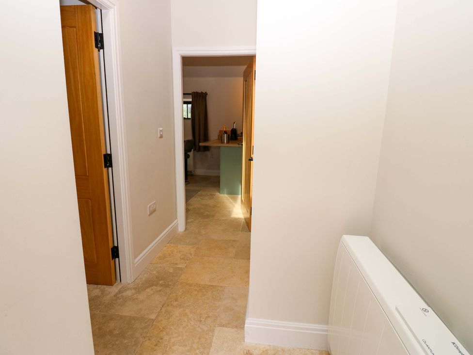 A hallway with two doors and a kitchen counter visible at Hadrian Barn 1 Ebchester