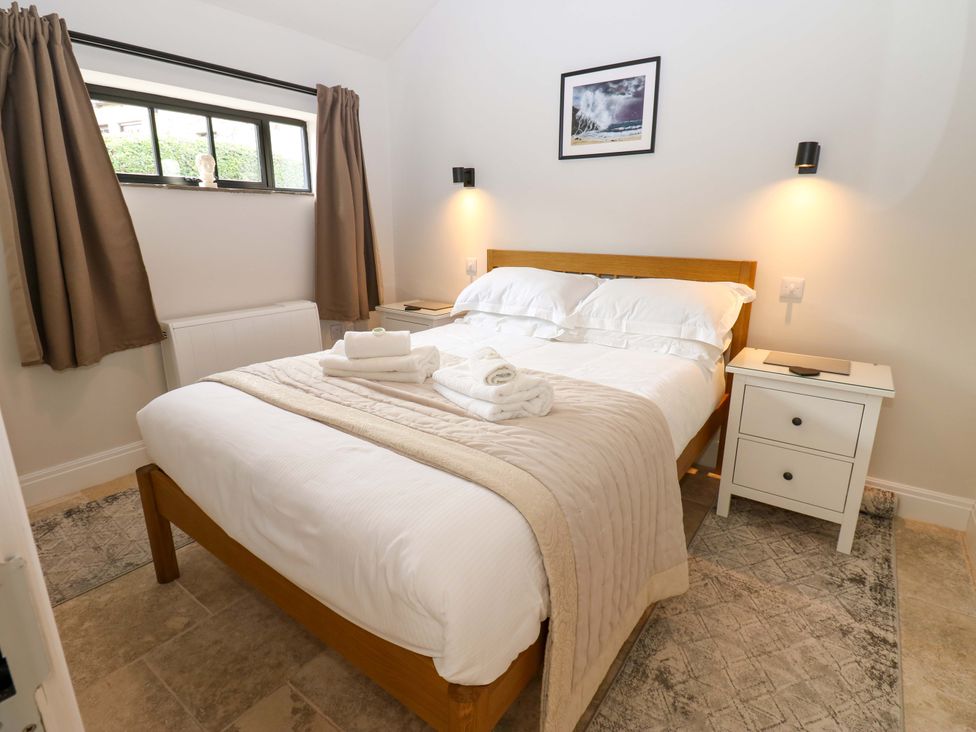 A bedroom with a bed and nightstand at Hadrian Barn 1 in Ebchester