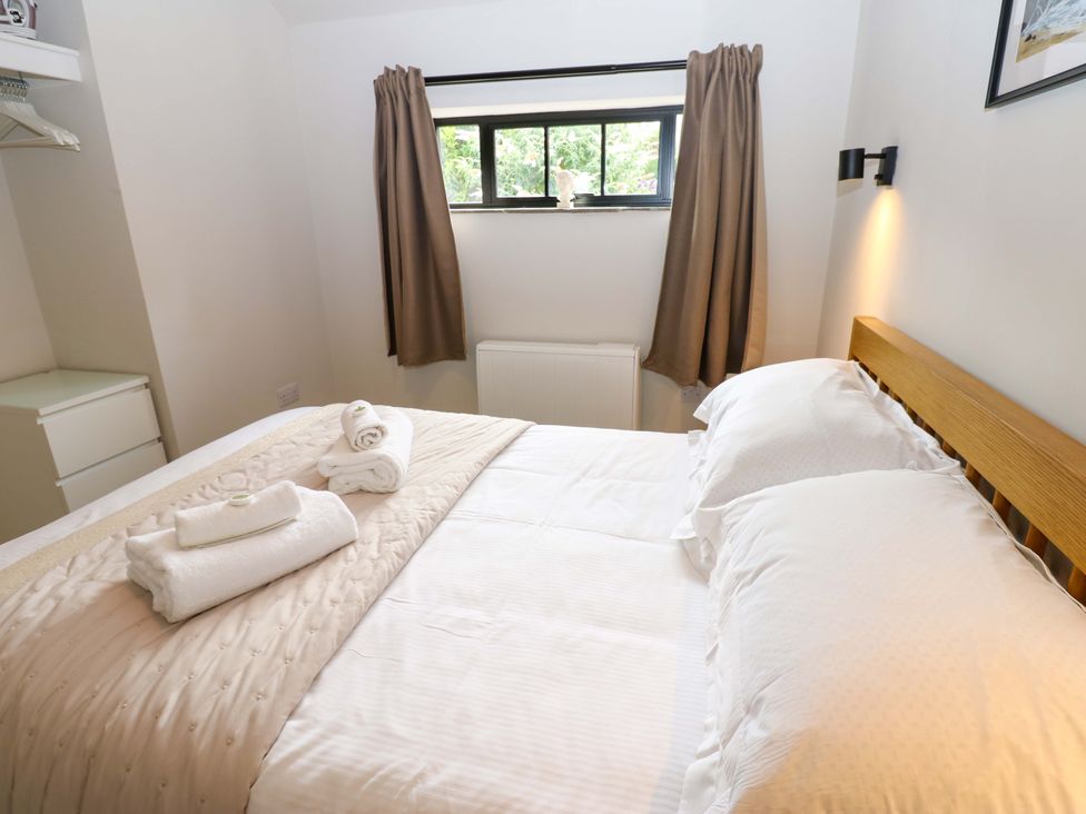 A bedroom with a bed and towels at Hadrian Barn 1 in Ebchester