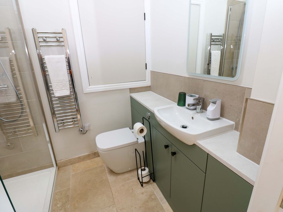 A bathroom with a sink, toilet, and shower at Hadrian Barn 1 Ebchester