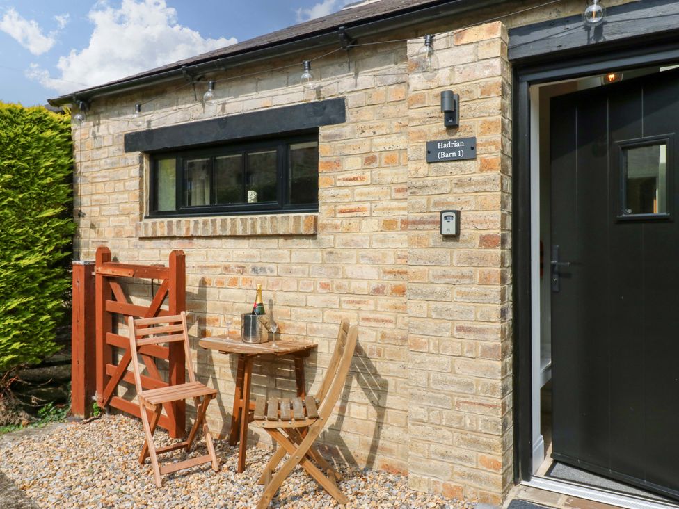 An outdoor area with a table and chairs at Hadrian Barn 1 in Ebchester