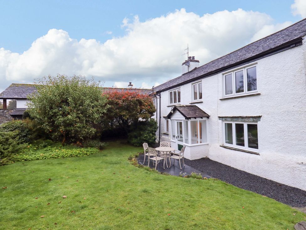 A house with a garden and seating area at Ecclerigg Old Farm near Ambleside