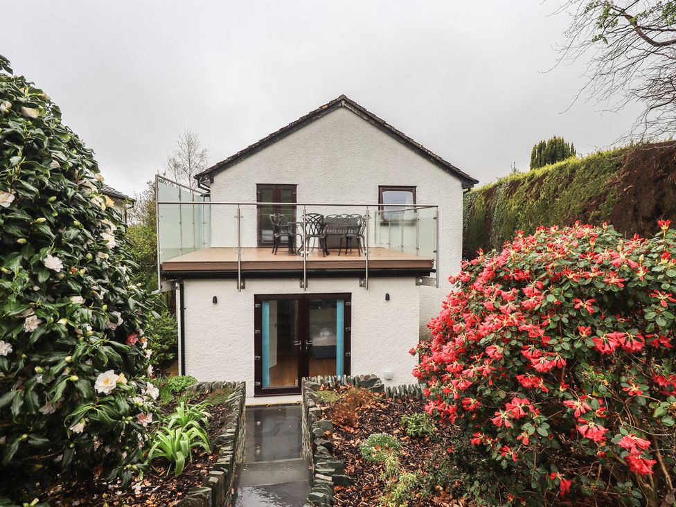 A house with balcony and garden flowers at Striding Home in Ambleside