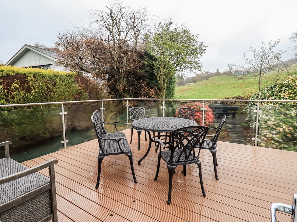 A patio with a table and chairs at Striding Home in Ambleside