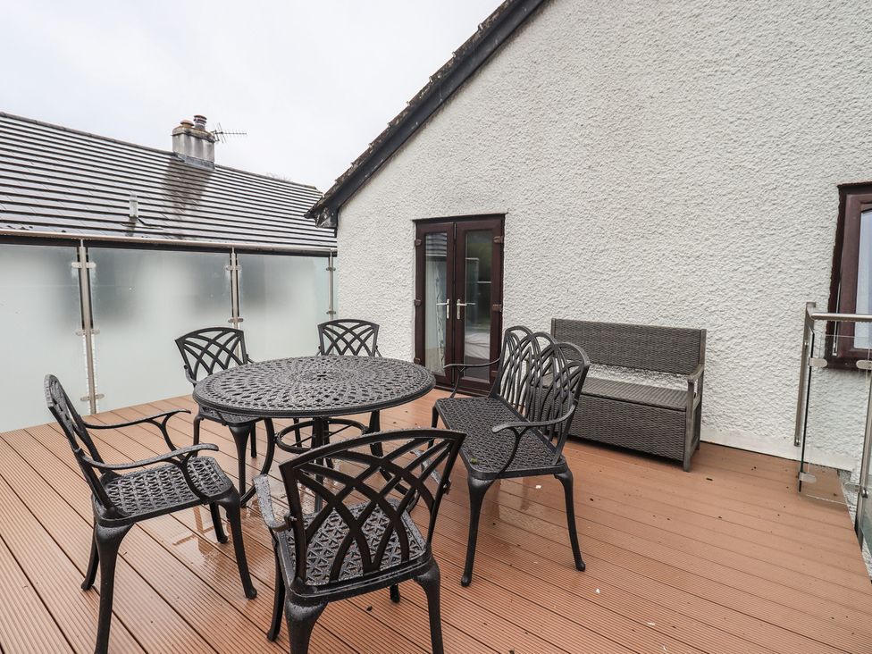 An outdoor area with a table and chairs at Striding Home in Ambleside