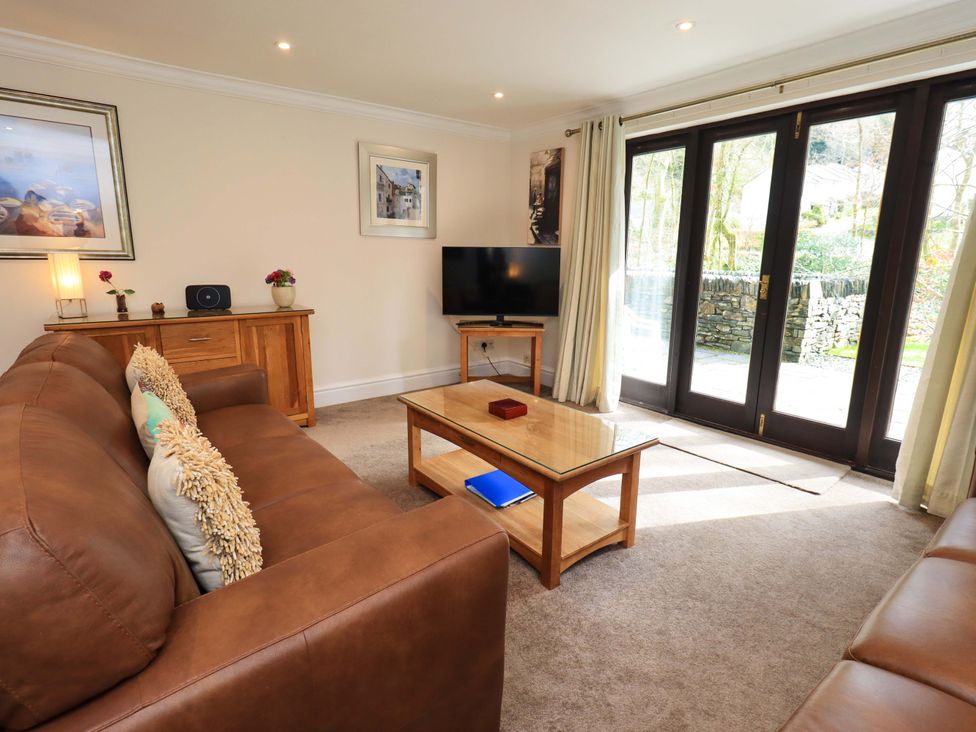 A living room with a sofa and coffee table at Gillybeck in Ambleside