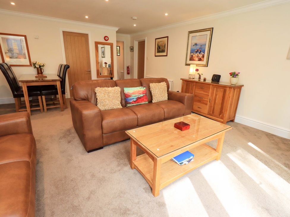 A living room with a sofa and coffee table at Gillybeck in Ambleside