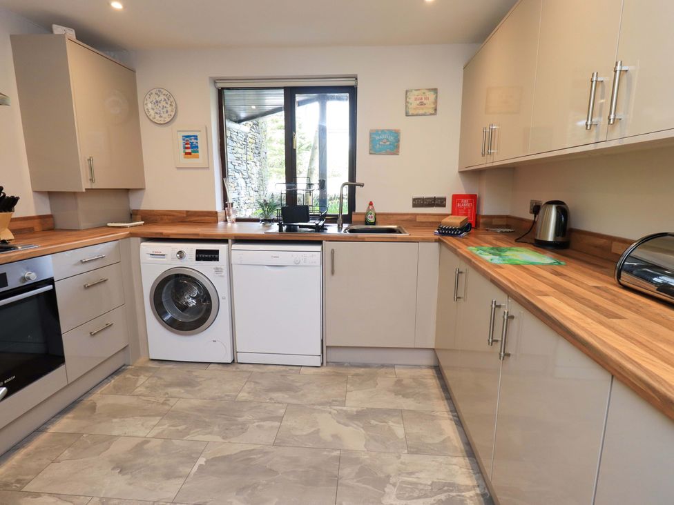 A kitchen with appliances and a window at Gillybeck in Ambleside