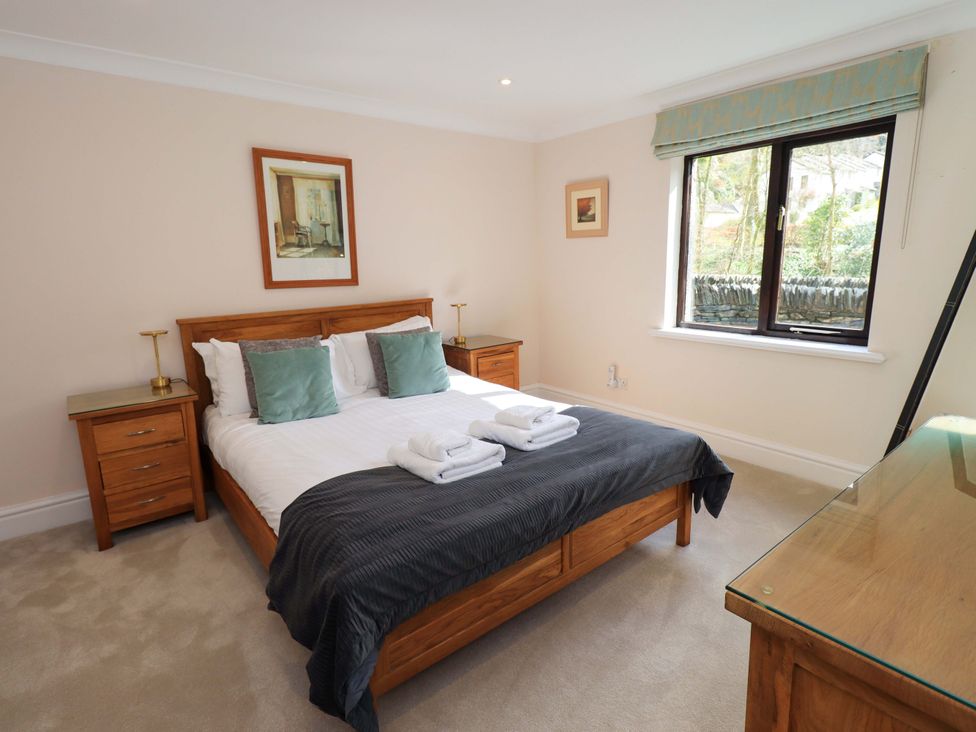 A bedroom with a bed and bedside tables at Gillybeck in Ambleside