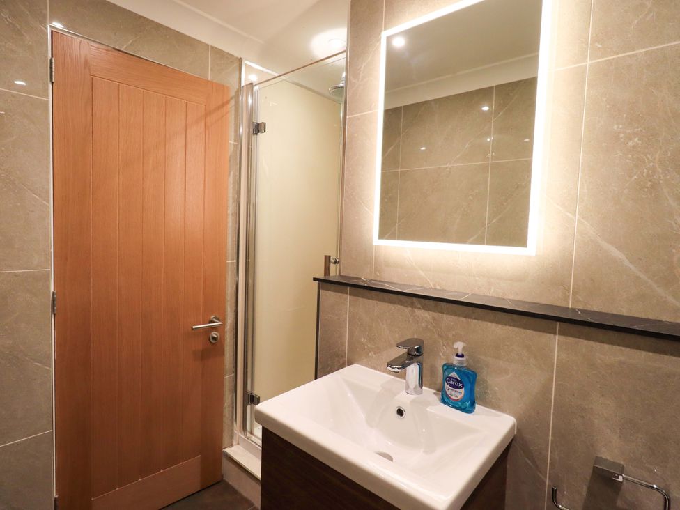 A bathroom with a shower and sink at Gillybeck in Ambleside