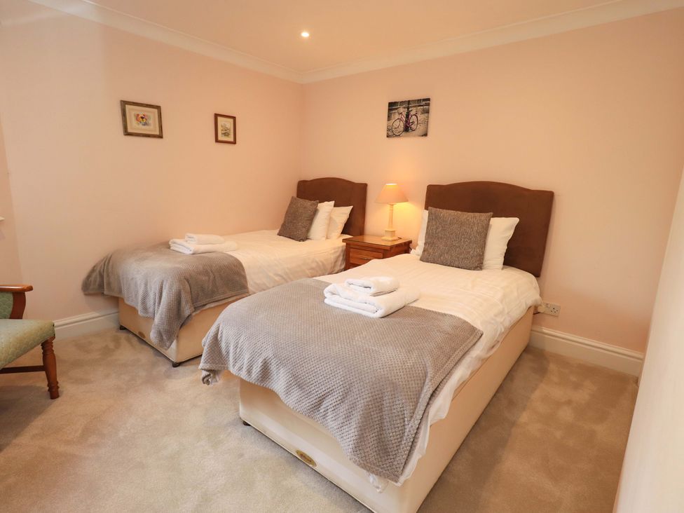 A bedroom with two single beds and a nightstand at Gillybeck in Ambleside