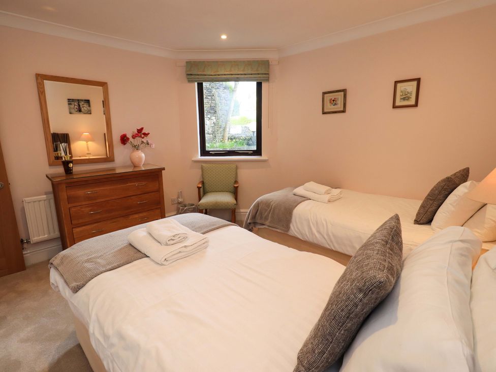 A bedroom with two beds and a dresser at Gillybeck in Ambleside
