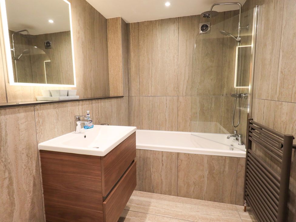 A bathroom with a bathtub and sink at Gillybeck in Ambleside