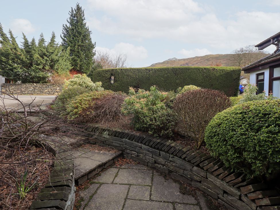 An outdoor area with a pathway and various bushes at Mardale in Ambleside