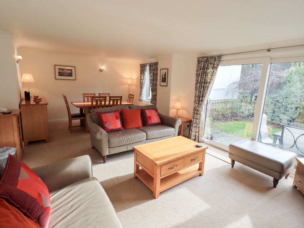 A living room featuring a sofa coffee table and dining area at Mardale in Ambleside