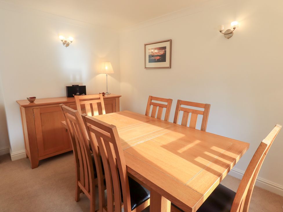 A dining room with a wooden table and chairs at Mardale in Ambleside
